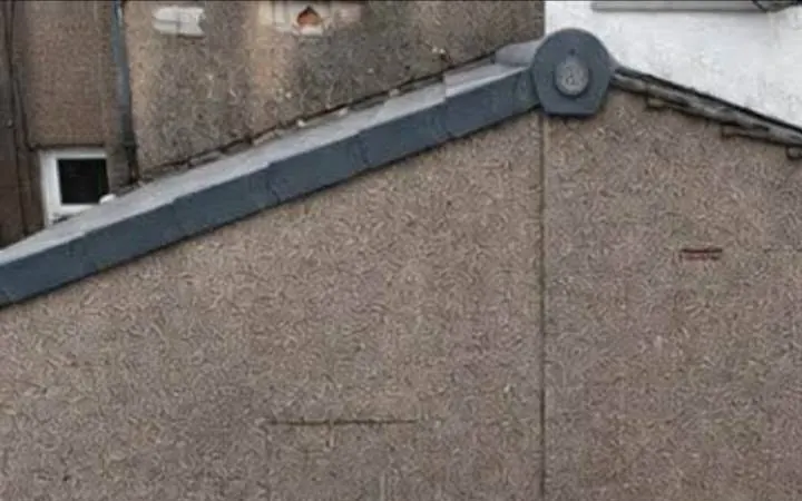 Grey dry verge caps along the edge of a gable roof with a round ridge end cap